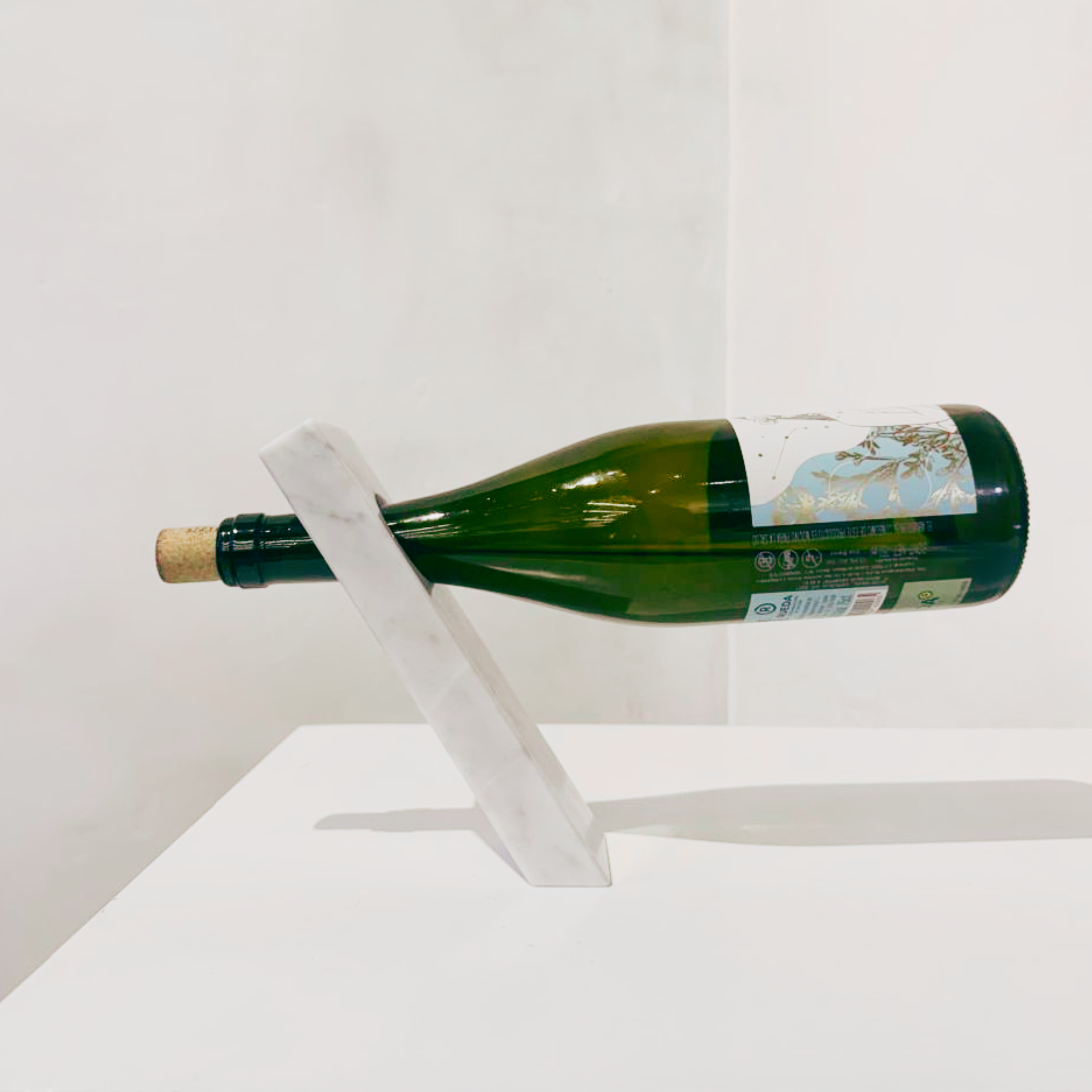 Marble inclined bottle holder.